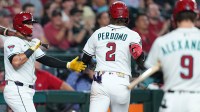Arizona Diamondbacks shortstop Geraldo Perdomo (2) slaps hands with Arizona Diamondbacks second base Ildemaro Vargas (6) after scoring a run against the San Francisco Giants during the first inning at Chase Field.