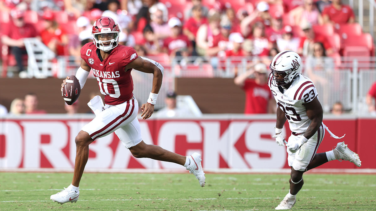 Arkansas Razorbacks quarterback Taylen Green (10) rushes out of the pocket as Alabama A&M Bulldogs defensive back Jeremiah Hudson-Davis (23) pursues during the third quarter at Donald W. Reynolds Razorback Stadium.