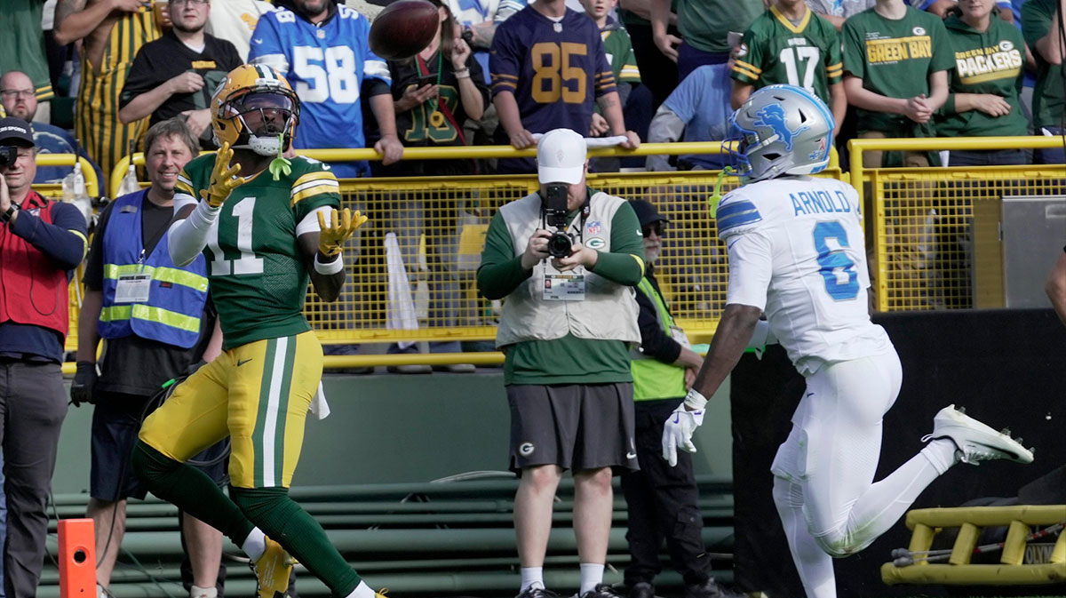 Green Bay Packers wide receiver Jayden Reed (11) catches a touchdown pass while being covered by Detroit Lions cornerback Terrion Arnold (6) during the second quarter of their game Sunday, September 7, 2025 at Lambeau Field in Green Bay, Wisconsin.