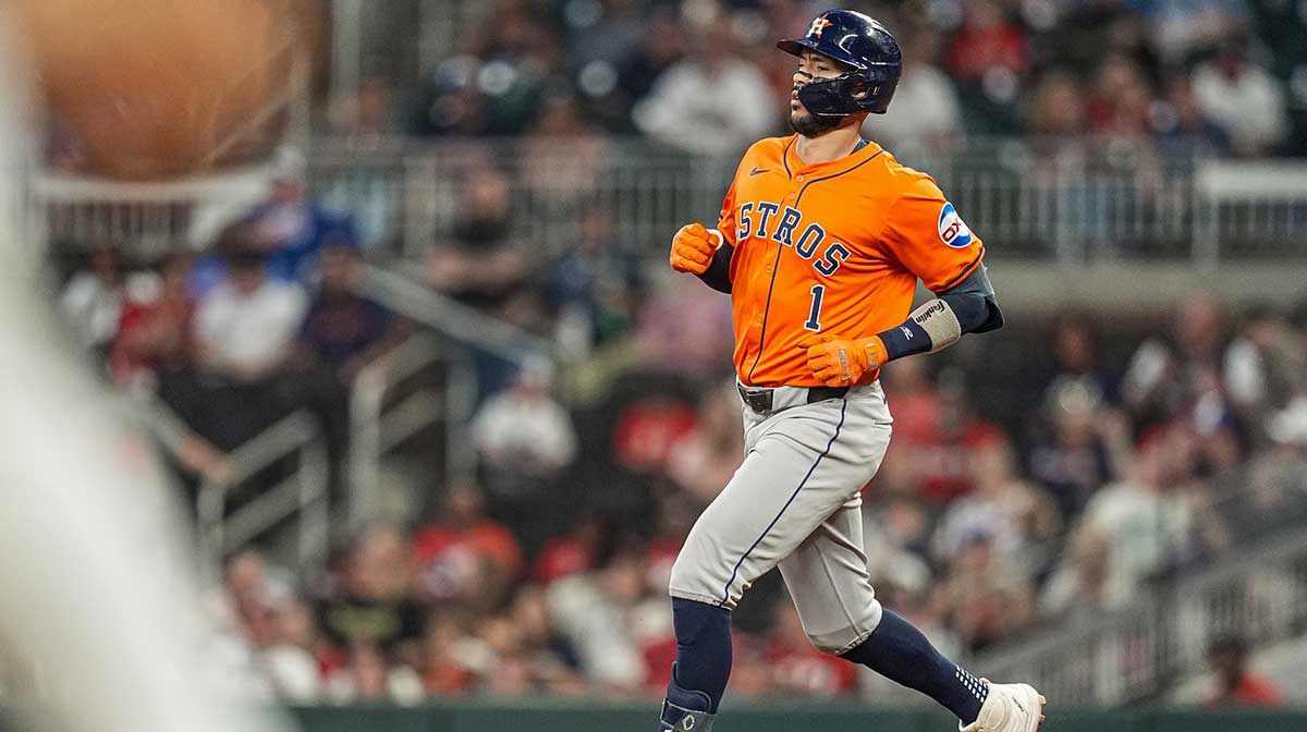 Houston Astros shortstop Carlos Correa (1) runs after hitting a double against the Atlanta Braves during the third inning at Truist Park.