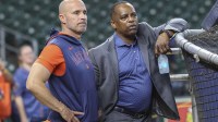 Houston Astros manager Joe Espada (left) and general manager Dana Brown (right) talk on the field before the game against the Chicago Cubs at Daikin Park.