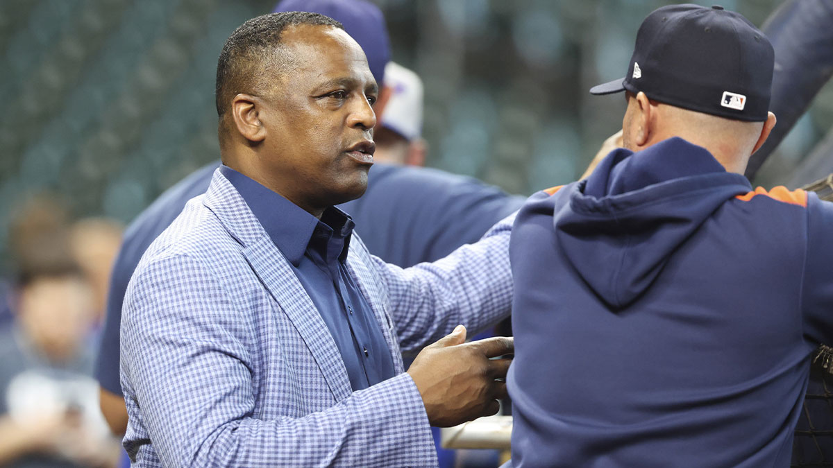 Houston Astros general manager Dana Brown talks on the field before the game against the New York Mets at Daikin Park.