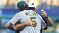 Pittsburgh Pirates former shortstop Jack Wilson rear) embraces his son Athletics shortstop Jacob Wilson (5) after both took part in a ceremonial first pitch before the Pirates host the Athletics at PNC Park.