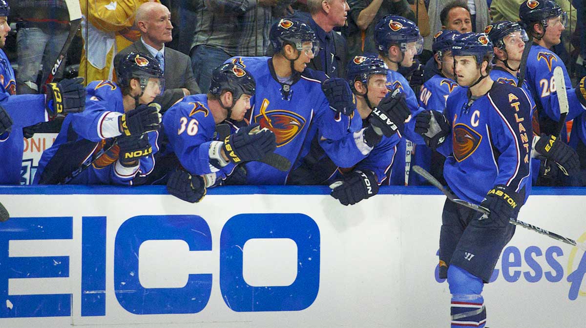 Atlanta Thrashers left wing Andrew Ladd (C) shakes hands with teammates on the bench after scoring the winning goal in the shootout against the Ottawa Senators at Philips Arena. The Thrashers defeated the Senators 5-4 in a shootout.