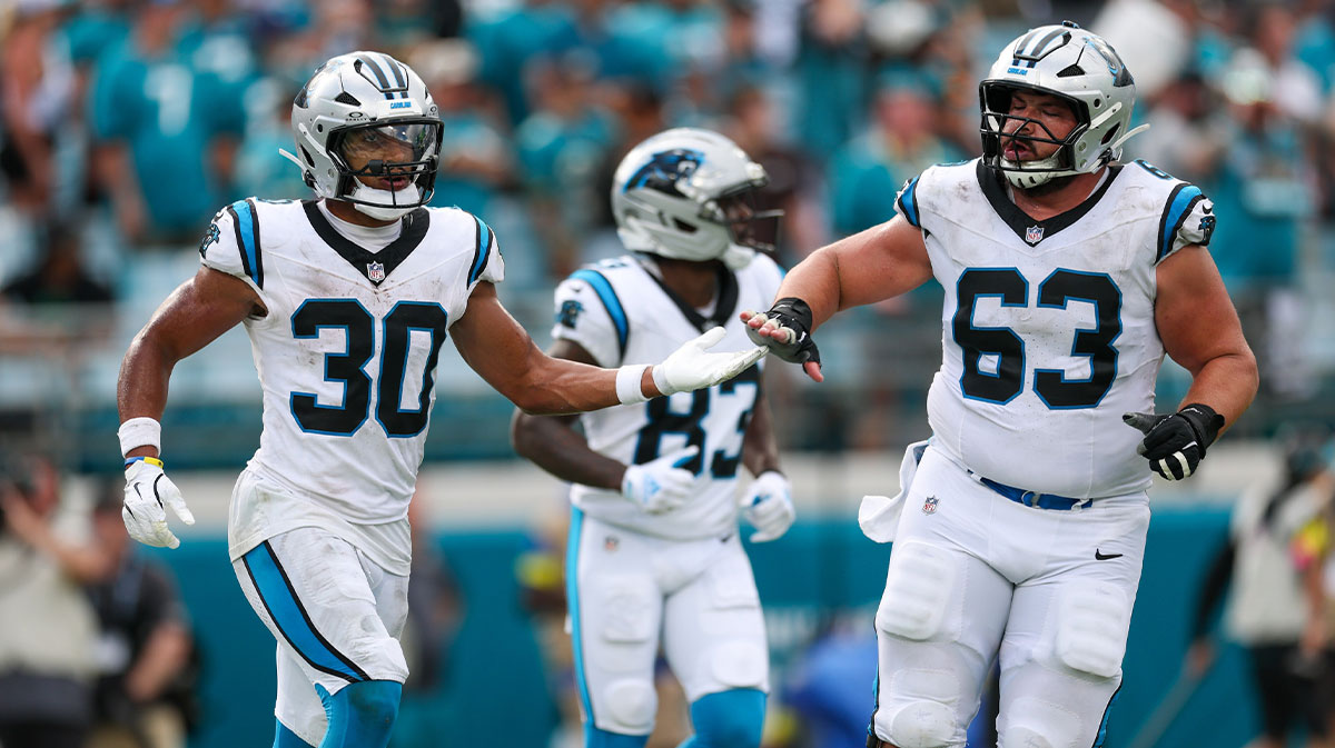 Carolina Panthers running back Chuba Hubbard (30) and center Austin Corbett (63) celebrate a touchdown against the Jacksonville Jaguars during the second half at EverBank Stadium.