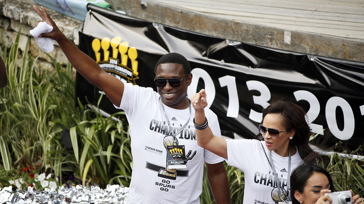 San Antonio Spurs former guard Avery Johnson waves to the fans during the NBA championship parade at San Antonio River Walk.