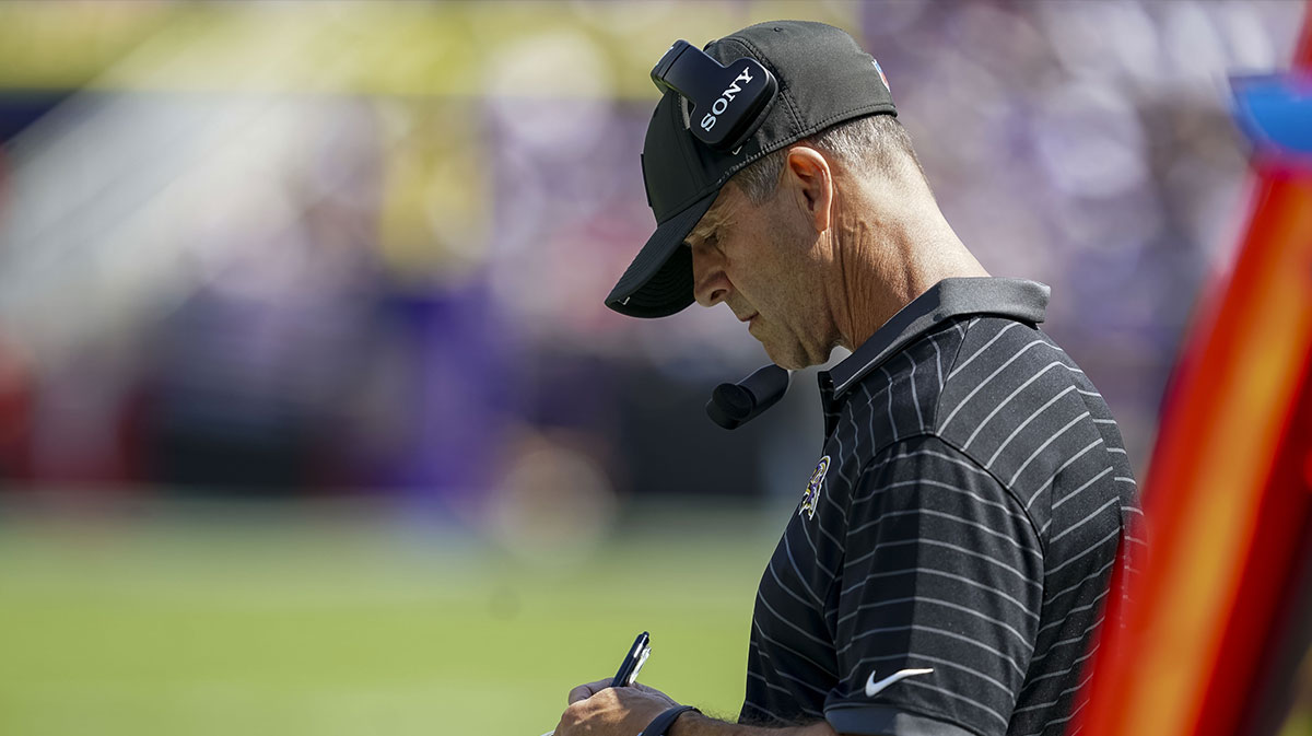 Baltimore Ravens head coach John Harbaugh takes notes during the first quarter at M&T Bank Stadium.