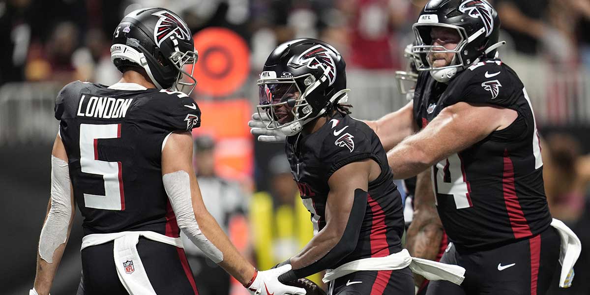 Atlanta Falcons running back Bijan Robinson (7) celebrates with wide receiver Drake London (5) after scoring a touchdown during the first half against the Washington Commanders at Mercedes-Benz Stadium.