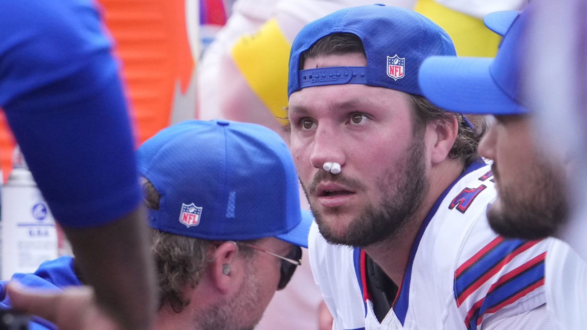 Buffalo Bills quarterback Josh Allen (17) is tended to by medical staff on the bench during the first half at MetLife Stadium.