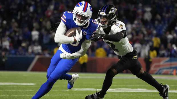 Buffalo Bills wide receiver Joshua Palmer (5) runs the ball against Baltimore Ravens cornerback Nate Wiggins (2) during the fourth quarter at Highmark Stadium.