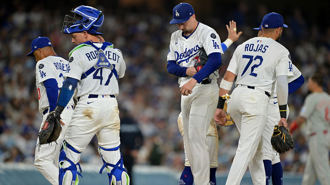 Los Angeles Dodgers starting pitcher Blake Snell (7) stays in the game as manager Dave Roberts (30), catcher Ben Rortvedt (47), second baseman Miguel Rojas (72) return to their positions for the third out of the seventh inning against the Philadelphia Phillies at Dodger Stadium. 