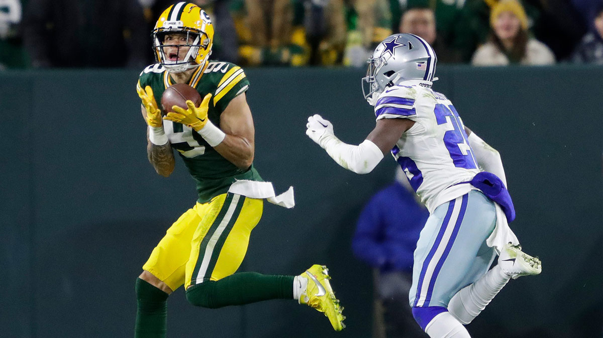 Green Bay Packers wide receiver Christian Watson (9) pulls down a touchdown reception against Dallas Cowboys cornerback DaRon Bland (26) in the fourth quarter during their football game Sunday, November 13, at Lambeau Field in Green Bay, Wis.