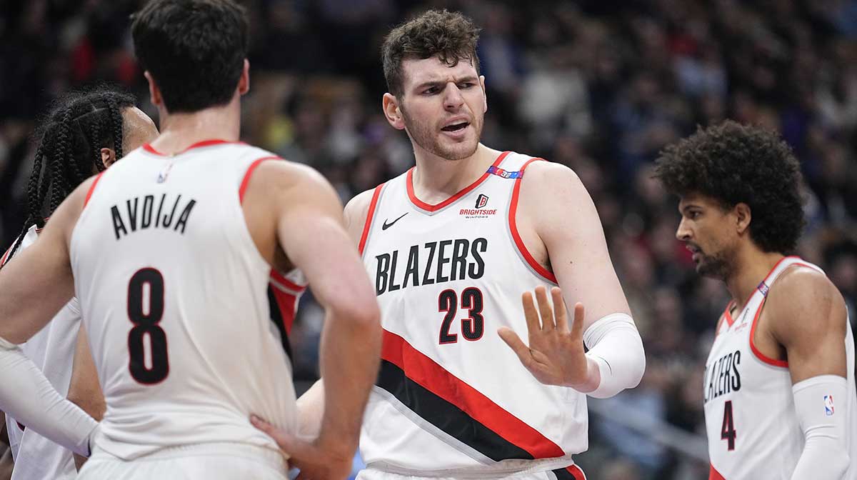  Portland Trail Blazers center Donovan Clingan (23) talks with Blazers forward Deni Avdija (8) during a break in the action against the Toronto Raptors during the first half at Scotiabank Arena. 