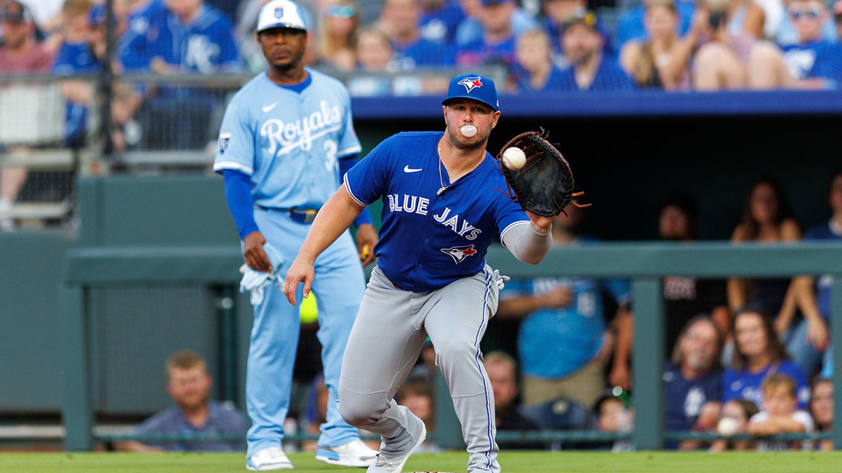 Toronto Blue Jays first base Ty France (2) reaches for a throw to first base during the second inning against the Kansas City Royals at Kauffman Stadium. 