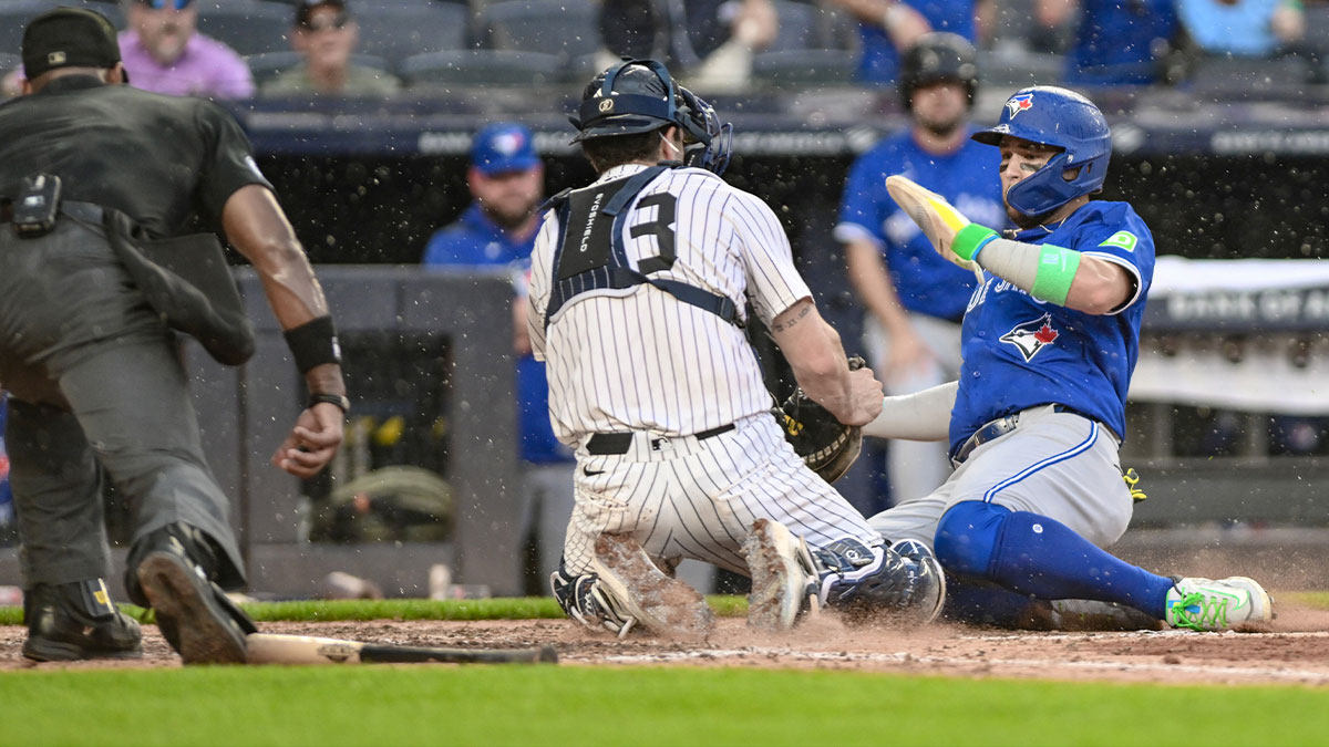 New York Yankees catcher Austin Wells (28) tags out Toronto Blue Jays shortstop Bo Bichette (11) at home plate during the sixth inning at Yankee Stadium.
