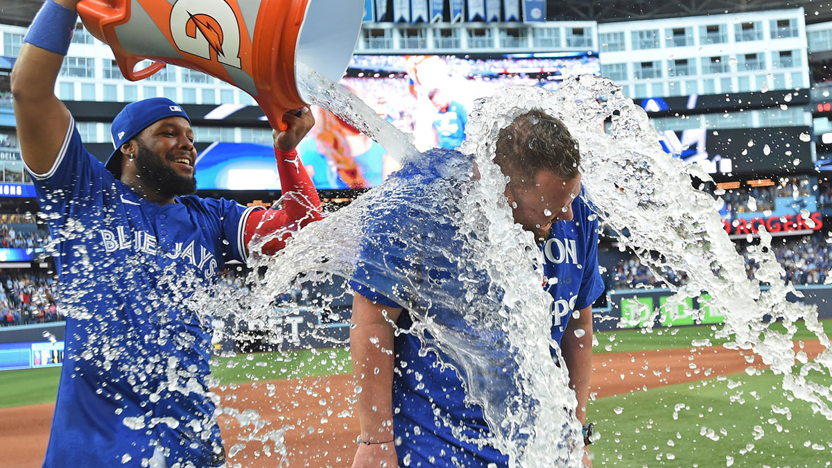 Blue Jays first baseman Vladimir Guerrero Jr. (27) douses manager John Schneider