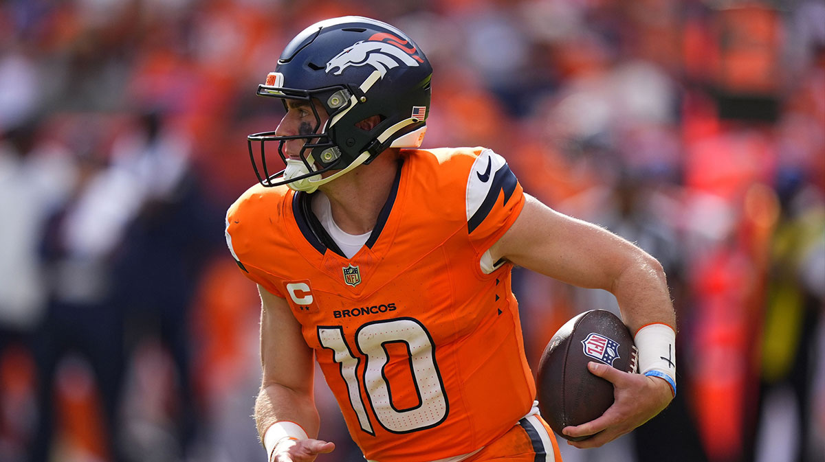 Denver Broncos quarterback Bo Nix (10) rushes the ball against the Tennessee Titans in the second half at Empower Field at Mile High