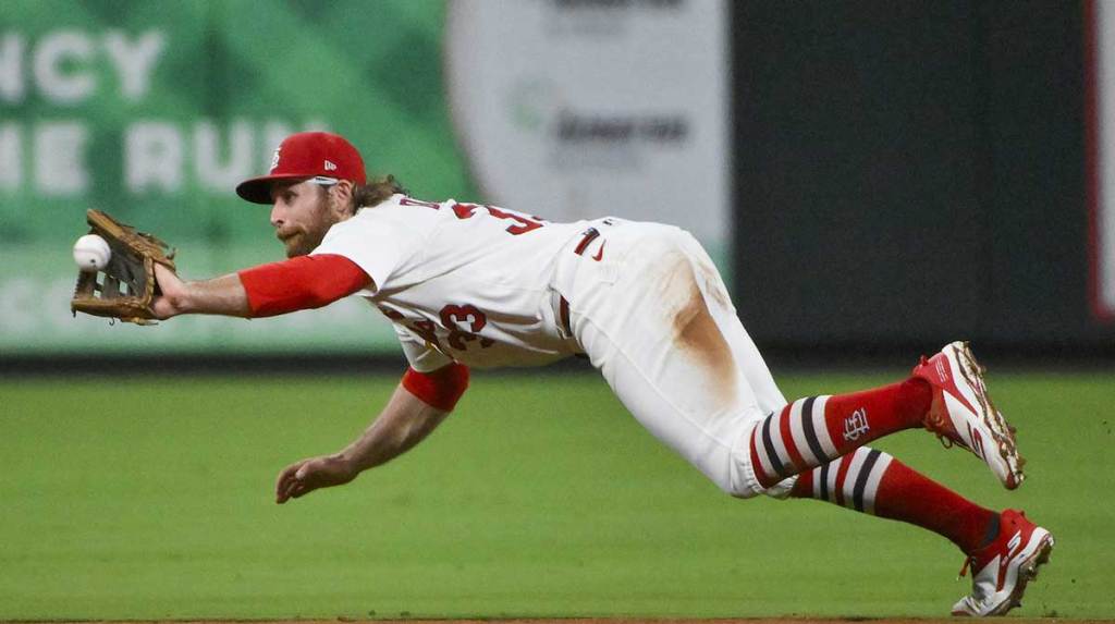 St. Louis Cardinals second baseman Brendan Donovan (33) dives and catches a line drive hit by Colorado Rockies center fielder Brenton Doyle (not pictured) during the seventh inning at Busch Stadium.