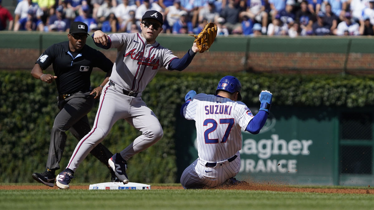 Chicago Cubs outfielder Seiya Suzuki (27) steals second base against Atlanta Braves shortstop Nick Allen (2) during the first inning during the first inning at Wrigley Field.