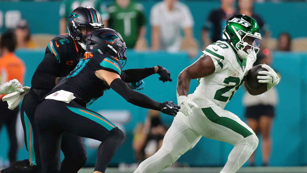 New York Jets running back Breece Hall (20) rushes the ball against the Miami Dolphins during the first half at Hard Rock Stadium.