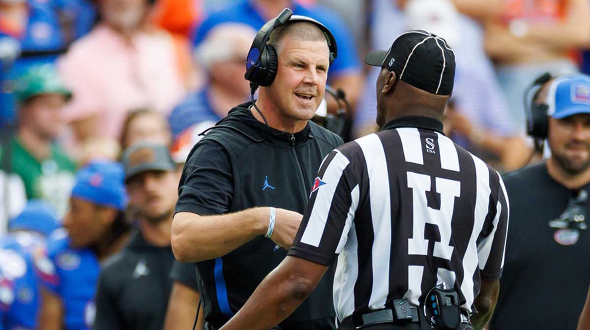 Florida Gators head coach Billy Napier discusses a call with the referee against the South Florida Bulls during the first half at Ben Hill Griffin Stadium.