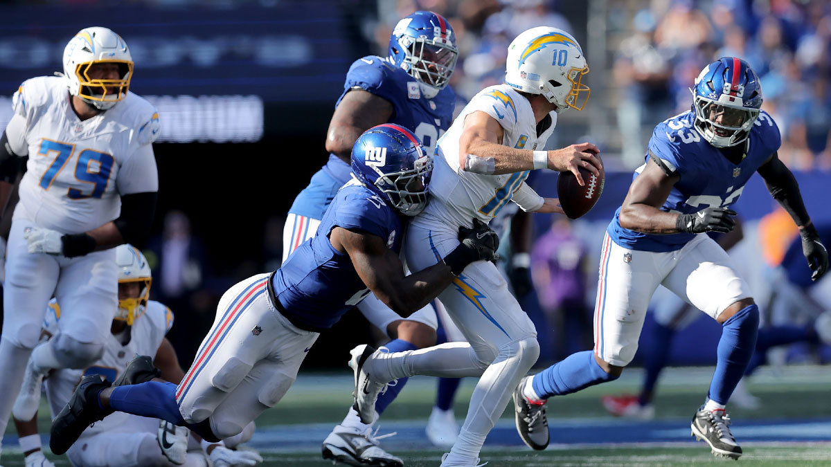 New York Giants linebacker Brian Burns (0) sacks Los Angeles Chargers quarterback Justin Herbert (10) during the fourth quarter at MetLife Stadium.