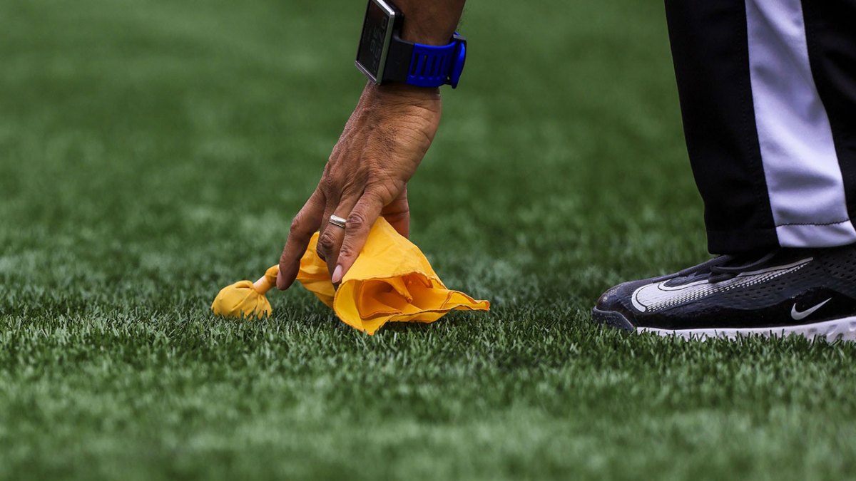 Line judge Greg Bradley (98) picks up a penalty flag during the first half in the game between the Jacksonville Jaguars and the Cincinnati Bengals at Paycor Stadium.
