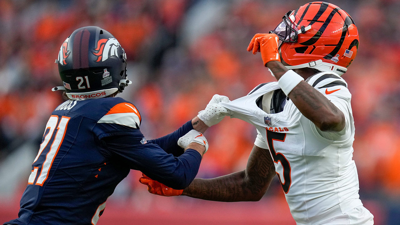 Denver Broncos cornerback Riley Moss (21) pulls on the jersey of Cincinnati Bengals wide receiver Tee Higgins (5) for a pass interference penalty in the first quarter of the NFL Week 4 Monday Night Football game between the Denver Broncos and the Cincinnati Bengals at Empower Field at Mile High in Denver on Monday, Sept. 29, 2025.