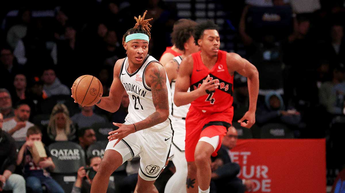 Brooklyn Nets forward Noah Clowney (21) brings the ball up court against Toronto Raptors forward Scottie Barnes (4) during the second quarter at Barclays Center.