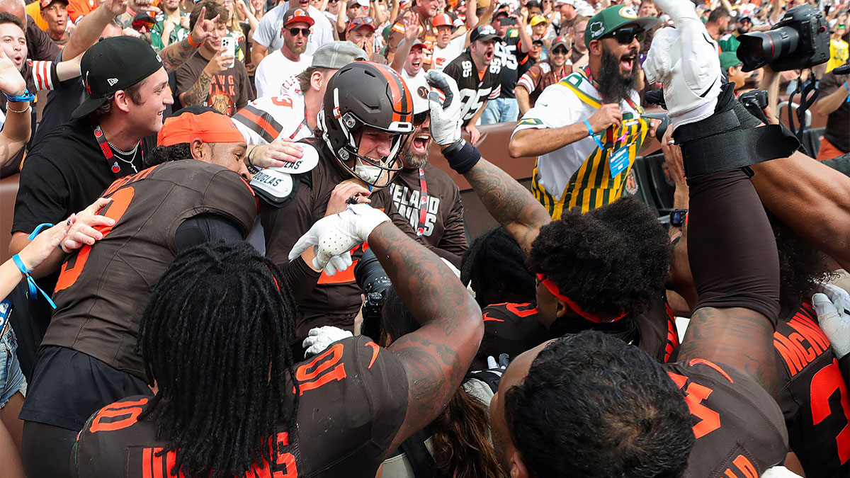 Browns kicker Andre Szmyt, center, is mobbed by teammates and fans after kicking the game-winning field goal to beat the Green Bay Packers, Sept. 21, 2025, in Cleveland.