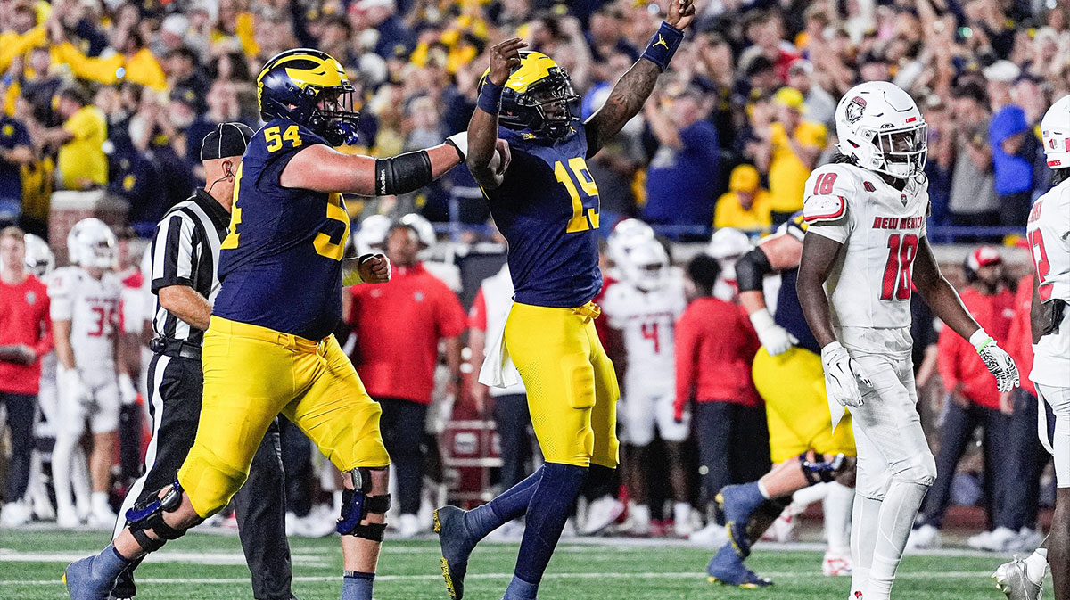 Michigan quarterback Bryce Underwood celebrates his first collegiate touchdown pass against New Mexico during the first half at Michigan Stadium