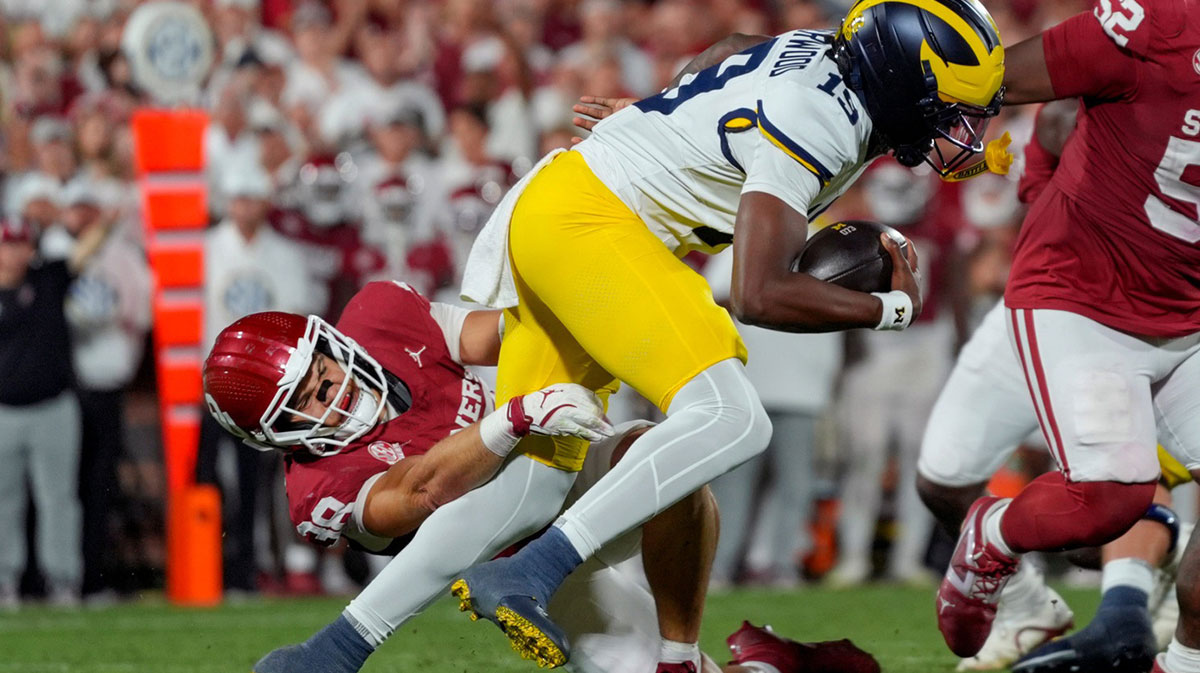 Oklahoma Sooners linebacker Owen Heinecke (38) brings down Michigan Wolverines quarterback Bryce Underwood (19) during a college football game between the University of Oklahoma Sooners (OU) and the University of Michigan Wolverines at Gaylord Family Ð Oklahoma Memorial Stadium in Norman, Okla., Saturday, Sept. 6, 2025. Oklahoma won 24-13.