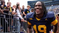 Michigan quarterback Bryce Underwood (19) smiles at fans as he walks up the tunnel after 63-3 win over Central Michigan at Michigan Stadium