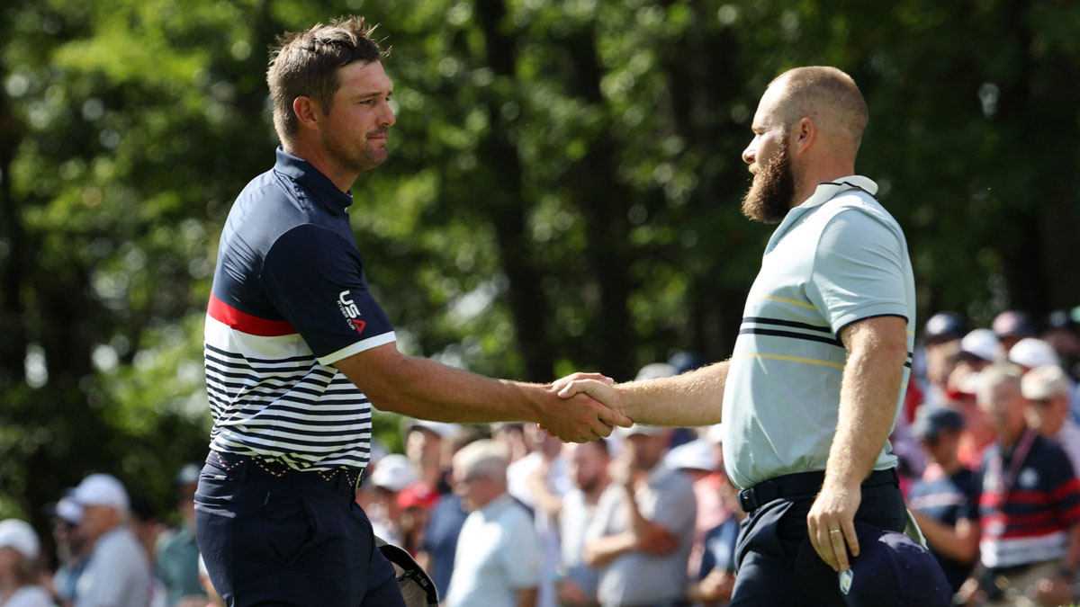 Team Europe golfer Tyrrell Hatton shakes hands with Team USA golfer Bryson DeChambeau after Team Europe win their match on the fifteenth hole on the first day of competition for the Ryder Cup at Bethpage Black