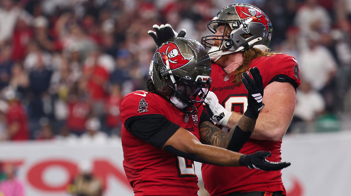 Tampa Bay Buccaneers wide receiver Emeka Egbuka (2) celebrates with Tampa Bay Buccaneers guard Cody Mauch (69) after scoring a touchdown during the second quarter against the Houston Texans at NRG Stadium.