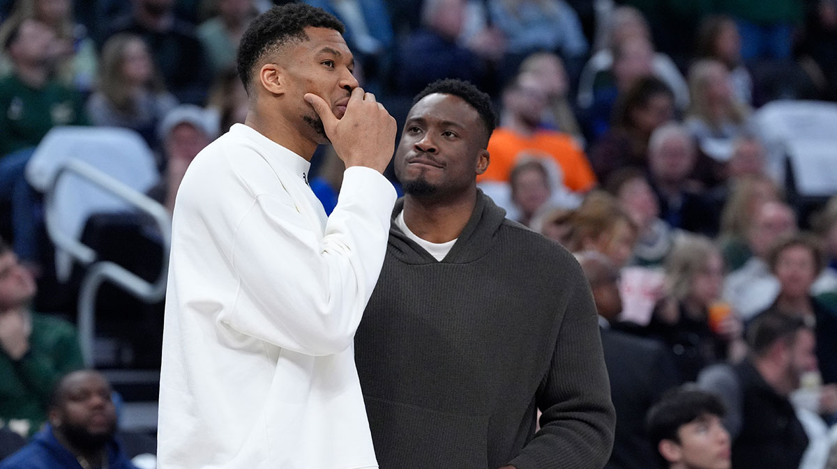 Bucks forward Giannis Antetokounmpo (34) and his brother Milwaukee Bucks forward Thanasis Antetokounmpo talks during a time out against the Detroit Pistons in the second half at Fiserv Forum with Jeff Teague in the background