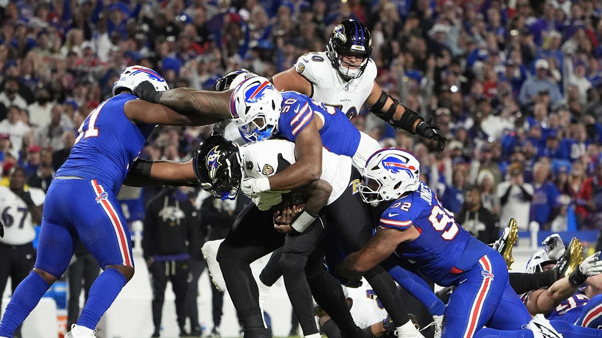 Buffalo Bills defensive end Greg Rousseau (50) tackles Baltimore Ravens quarterback Lamar Jackson (8)