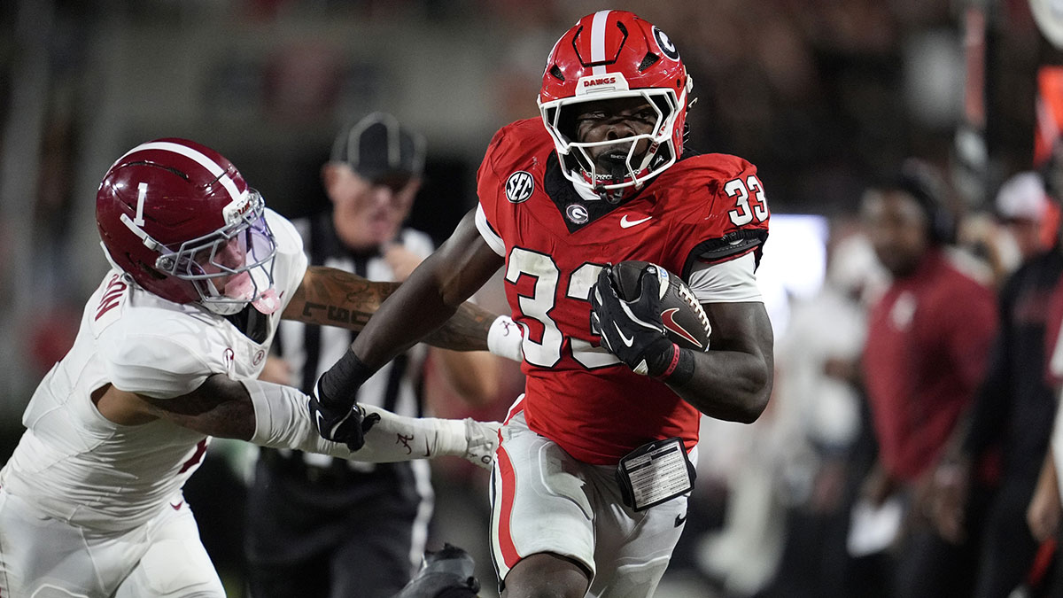 Georgia Bulldogs running back Chauncey Bowens (33) runs against Alabama Crimson Tide defensive back Domani Jackson (1) in the second half at Sanford Stadium.
