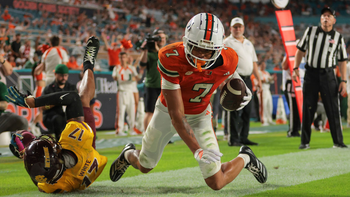 Miami Hurricanes wide receiver CJ Daniels (7) scores a touchdown against Bethune-Cookman Wildcats cornerback Gabe White (17) during the second quarter at Hard Rock Stadium. Mandatory Credit: Sam Navarro-Imagn Images