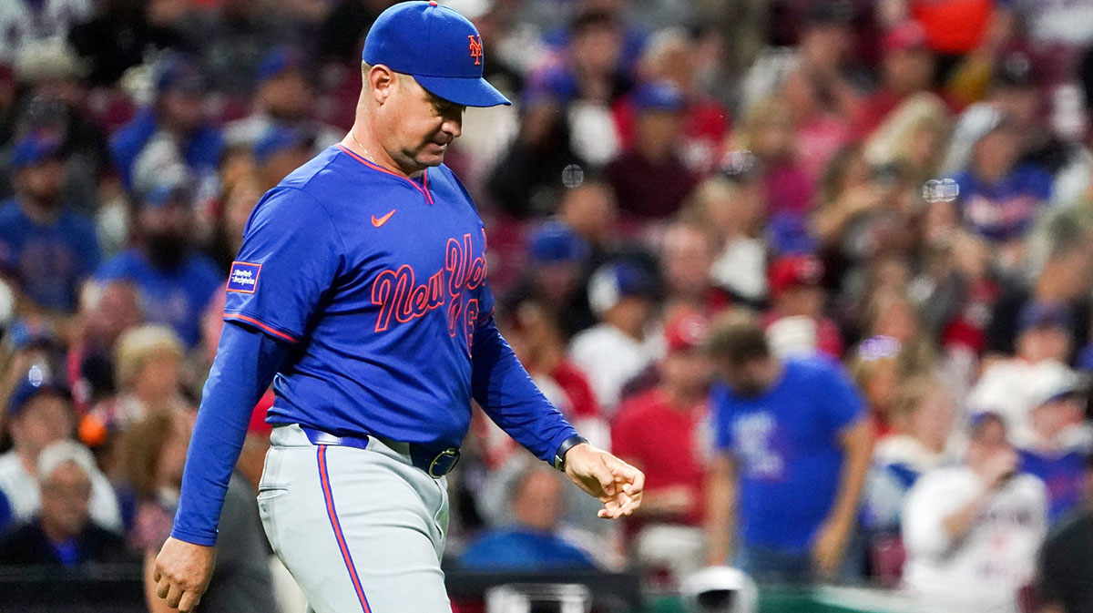 New York Mets manager Carlos Mendoza (64) walks to the pitchers mound in the seventh inning of a MLB game between the Cincinnati Reds and New York Mets.