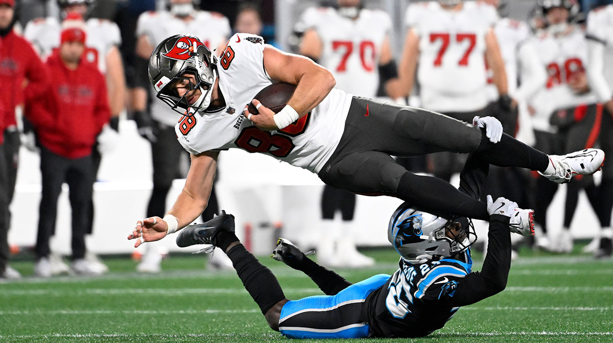 Tampa Bay Buccaneers tight end Cade Otton (88) is tackled by Carolina Panthers cornerback Chau Smith-Wade (26) in overtime at Bank of America Stadium.