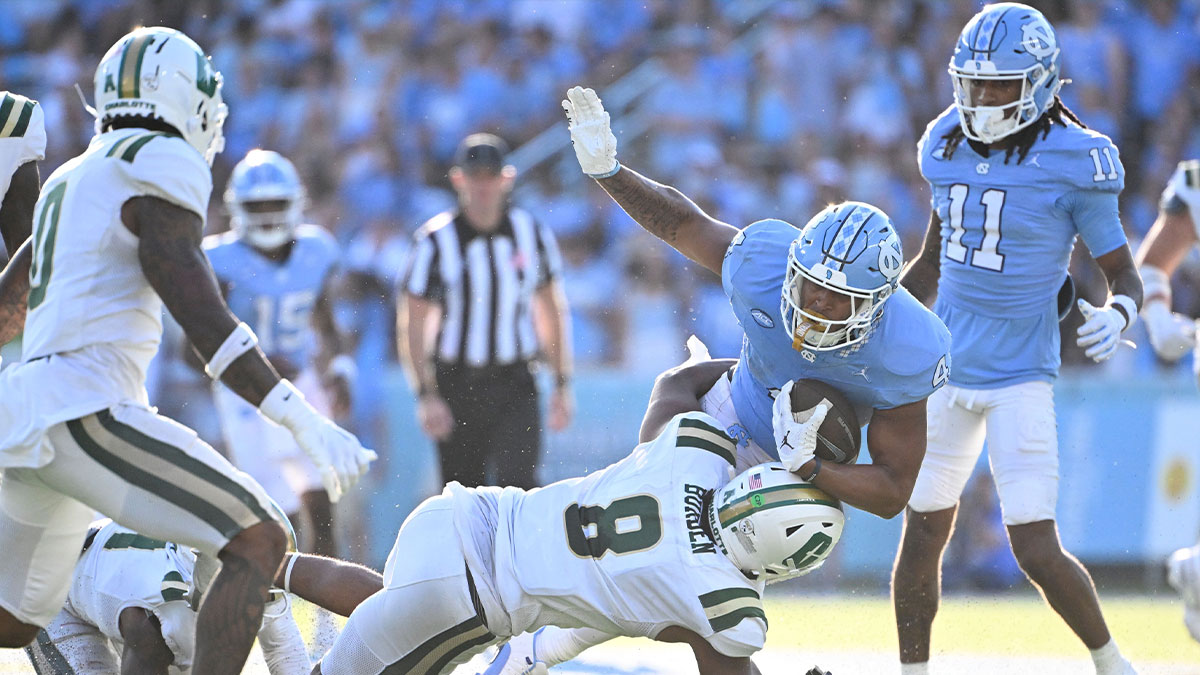 North Carolina Tar Heels running back Caleb Hood (4) is tackled by Charlotte 49ers linebacker Cam Burden (8) in the third quarter at Kenan Memorial Stadium.