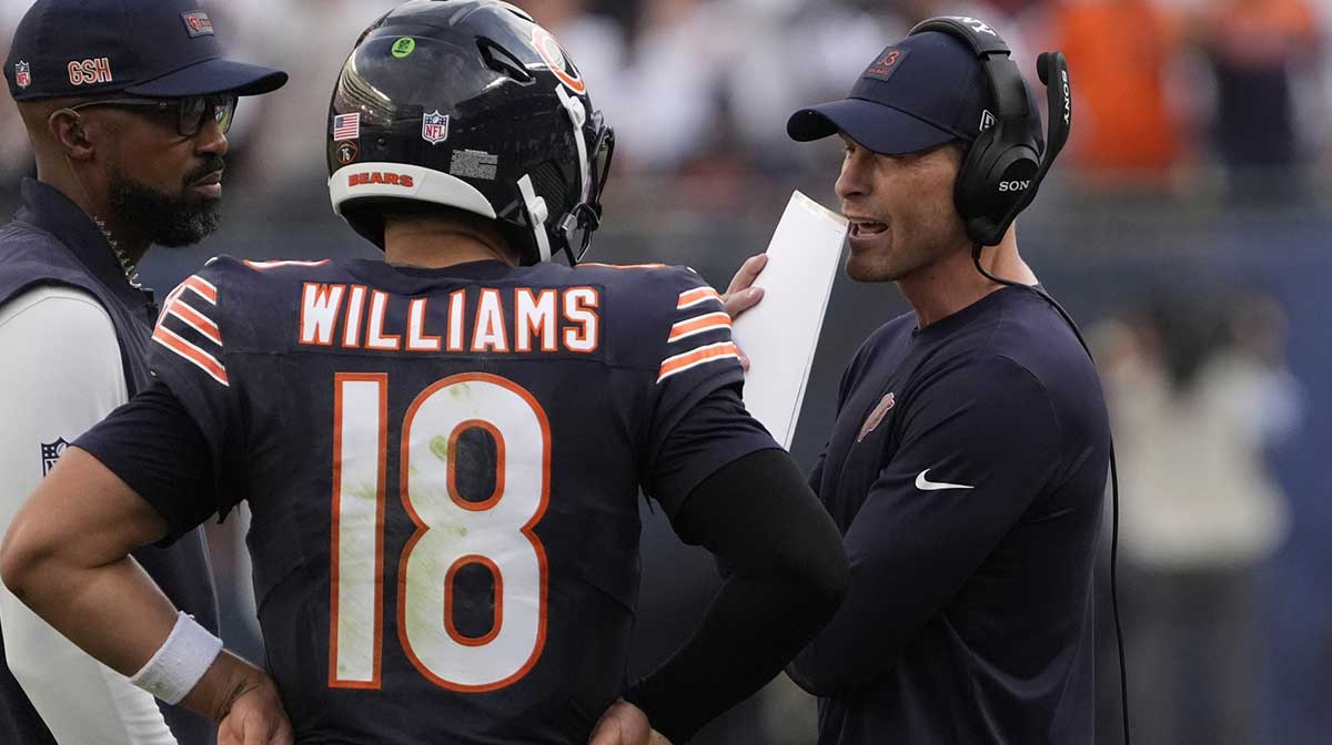 Chicago Bears head coach Ben Johnson talks with quarterback Caleb Williams (18) against the Dallas Cowboys during the second half at Soldier Field.
