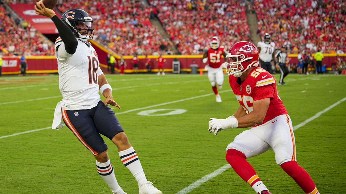 Chicago Bears quarterback Caleb Williams (18) throws a pass against Kansas City Chiefs defensive end George Karlaftis (56) during the first half at GEHA Field at Arrowhead Stadium.