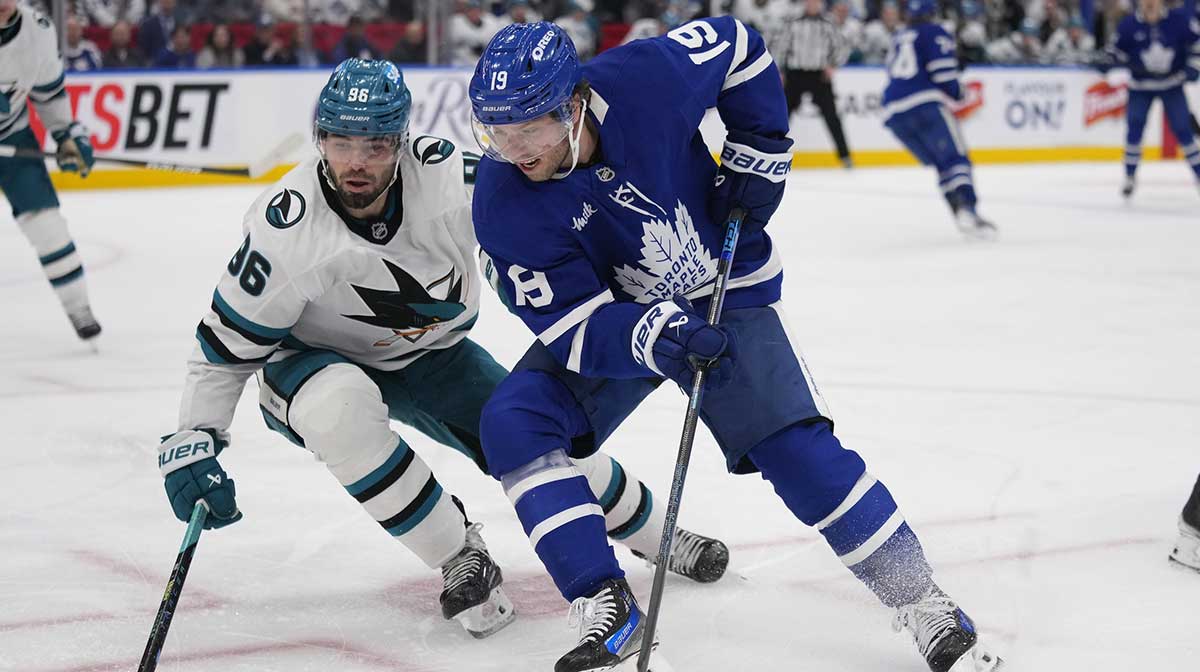 Toronto Maple Leafs forward Calle Jarnkrok (19) and San Jose Sharks defenseman Jake Walman (96) battle for a puck during the period at Scotiabank Arena.