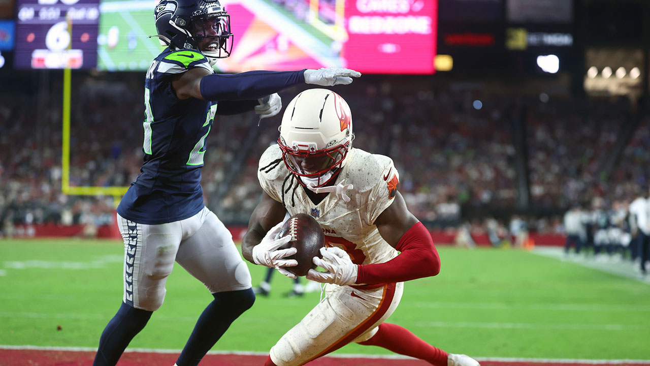 Arizona Cardinals wide receiver Marvin Harrison Jr. (18) makes a catch for a touchdown against Seattle Seahawks cornerback Devon Witherspoon (21) in the fourth quarter at State Farm Stadium.