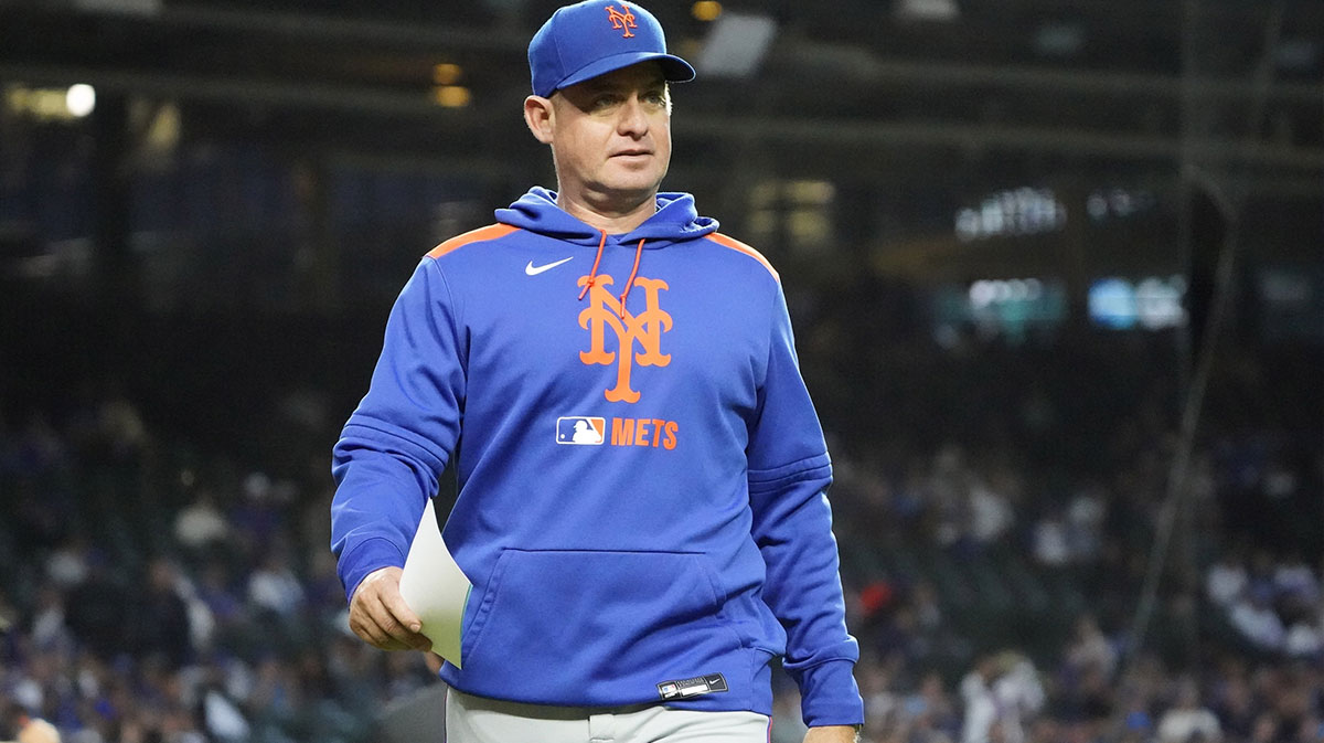New York Mets manager Carlos Mendoza (64) on the field before a game against the Chicago Cubs at Wrigley Field.