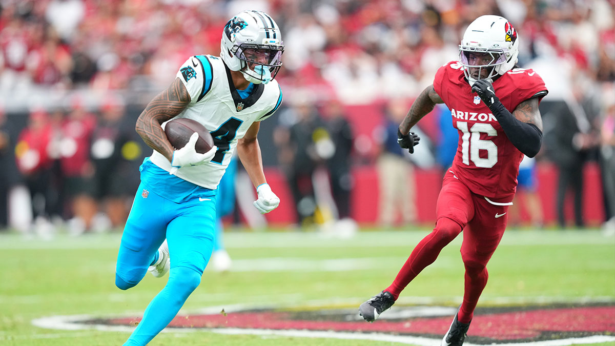 Carolina Panthers wide receiver Tetairoa McMillan (4) runs with the ball during the first quarter against Arizona Cardinals cornerback Max Melton (16) at State Farm Stadium.