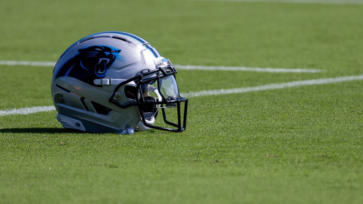 A Carolina Panthers helmet sits on the ground at training camp.