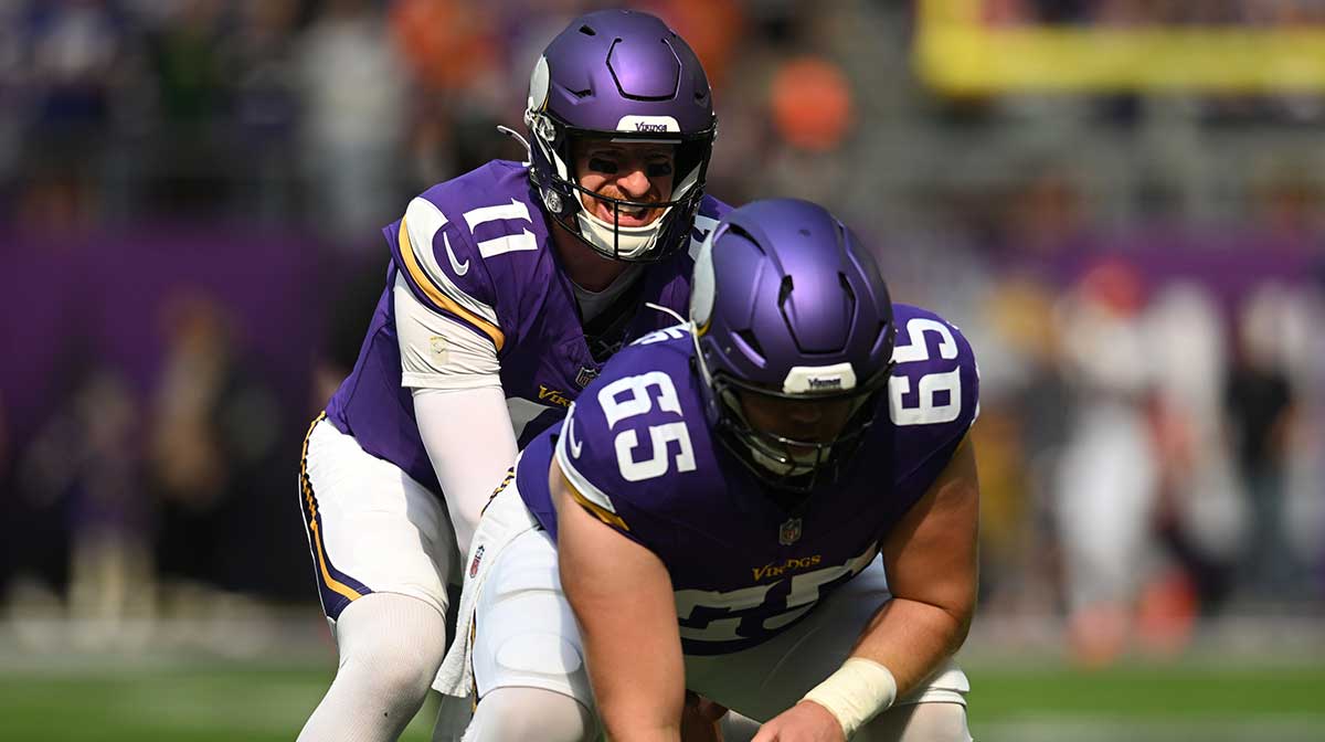 Minnesota Vikings quarterback Carson Wentz (11) warms up with center Michael Jurgens (65) prior to a game against the Cincinnati Bengals at U.S. Bank Stadium.